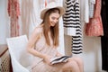 Cheerful woman reading magazine in clothes shop Royalty Free Stock Photo