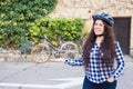 Cheerful woman represnt a bycycle on the background alley