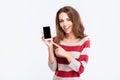 Cheerful woman showing blank smartphone screen Royalty Free Stock Photo