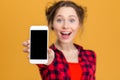 Cheerful woman showing blank smartphone screen Royalty Free Stock Photo