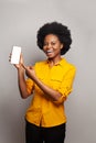 Cheerful woman showing empty blank screen display smart phone and smiling on white