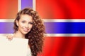 Cheerful woman showing white banner on the Norway flag background. Live, work, education and internship in Norway Royalty Free Stock Photo