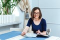 Cheerful woman sitting and reading magazine in cafe Royalty Free Stock Photo