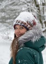 Cheerful Woman in Snow-Dusted Hat in Winter Forest Royalty Free Stock Photo