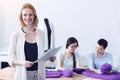 Cheerful woman standing with the documents for her colleagues