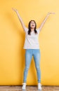 Cheerful woman standing with raised hands Royalty Free Stock Photo