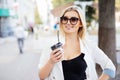 Cheerful woman in the street drinking morning coffee. Coffee to go Royalty Free Stock Photo