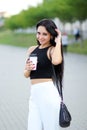 Cheerful woman in the street drinking morning coffee in sunshine Royalty Free Stock Photo