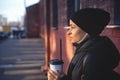 Cheerful woman in the street drinking morning coffee at winter time Royalty Free Stock Photo