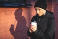 Cheerful woman in the street drinking morning coffee at winter time Royalty Free Stock Photo