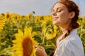 Cheerful woman in a sunflower field landscape nature sun agriculture Royalty Free Stock Photo