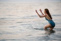 Cheerful woman in swimsuit playing water splashing on the sea beach at Koh Chang island, Thailand Royalty Free Stock Photo