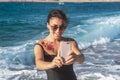 Cheerful woman in a swimsuit takes a selfie by the sea Royalty Free Stock Photo