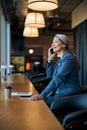 Cheerful woman talking on cellphone at business center Royalty Free Stock Photo