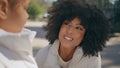 Cheerful woman talking daughter in sunny park close up. African family weekend. Royalty Free Stock Photo