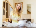 Cheerful woman unpacking new electric steamer