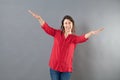 Cheerful woman using arms and hands like bird to fly