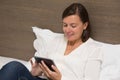 Cheerful woman using her laptop in the bedroom Royalty Free Stock Photo