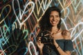 Cheerful woman using an instant camera