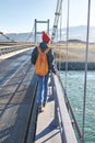 Cheerful woman walks on the brige in Jokulsarlon Ice Lagoon Royalty Free Stock Photo