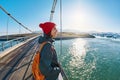 Cheerful woman walks on the brige in Jokulsarlon Ice Lagoon Royalty Free Stock Photo