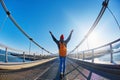 Cheerful woman walks on the brige in Jokulsarlon Ice Lagoon Royalty Free Stock Photo