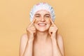 Cheerful woman with white smile and clean skin pointing fingers on patches under her eyes doing skin care beauty treatment Royalty Free Stock Photo