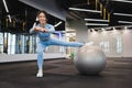 Cheerful woman working out with a fitness ball in the gym. Royalty Free Stock Photo