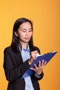 Cheerful woman writing business report on clipboard Royalty Free Stock Photo