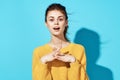 cheerful woman in yellow sweater studio posing fashion positive