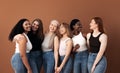 Cheerful women of different body types and ages standing together in studio