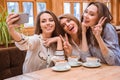 Cheerful women making selfie photo on smartphone Royalty Free Stock Photo