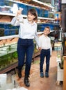 Woman with boy looking for aquarium fishes Royalty Free Stock Photo