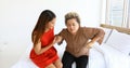 Cheerful woman taking care of her grandmother in bed room at home Royalty Free Stock Photo