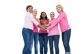 Cheerful women wearing breast cancer ribbons with hands together