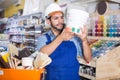 Cheerful workman choosing materials