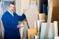 Cheerful workman standing with plywood pieces Royalty Free Stock Photo