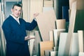 Cheerful workman standing with plywood pieces Royalty Free Stock Photo