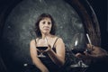 Cheerful 40 years old woman in classic dress with glass of wine Royalty Free Stock Photo