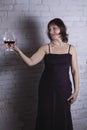 Cheerful 40 years old woman in classic dress with glass of wine Royalty Free Stock Photo