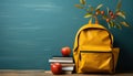 A cheerful yellow backpack and a fresh apple on a vibrant blue background with books, educational picture Royalty Free Stock Photo