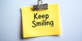Cheerful Yellow Reminder Note with Optimistic Sentiment to Keep Smiling and Spread Positivity Royalty Free Stock Photo