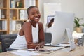 Cheerful young african american business woman smiling and working on a computer in an office. Bald female entrepreneur Royalty Free Stock Photo