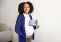 Cheerful young african american curly pregnant woman with belly in casual show ultrasound picture of unborn baby Royalty Free Stock Photo