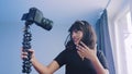 Cheerful young African American female blogger holding camera and recording video for vlog while standing near the Royalty Free Stock Photo