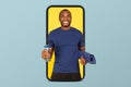 Cheerful young african american guy athlete coach in sportswear with mat and bottle of water on smartphone