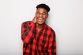 Cheerful young African american man laughing against gray background Royalty Free Stock Photo