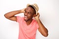 Cheerful young african american man laughing with hat against isolated white background Royalty Free Stock Photo