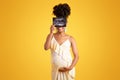 Cheerful young african american pregnant lady in dress touching big belly, show ultrasound shot Royalty Free Stock Photo