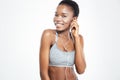 Cheerful young african american sportswoman listening to music with earphones Royalty Free Stock Photo